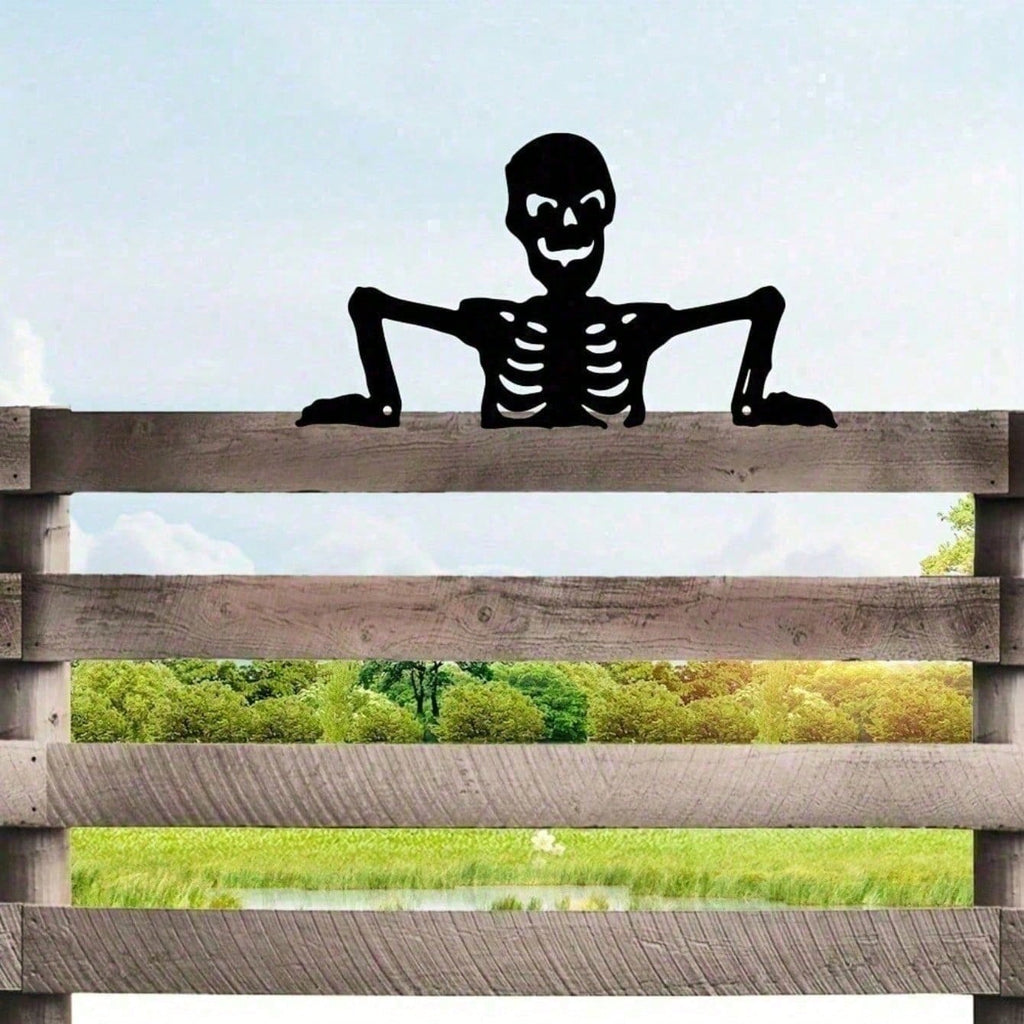 Black skeleton silhouette peeking over a wooden fence rail
