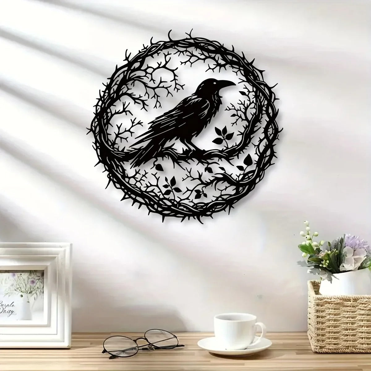 Crow in a thorn wreath wall art on a sunlit wall