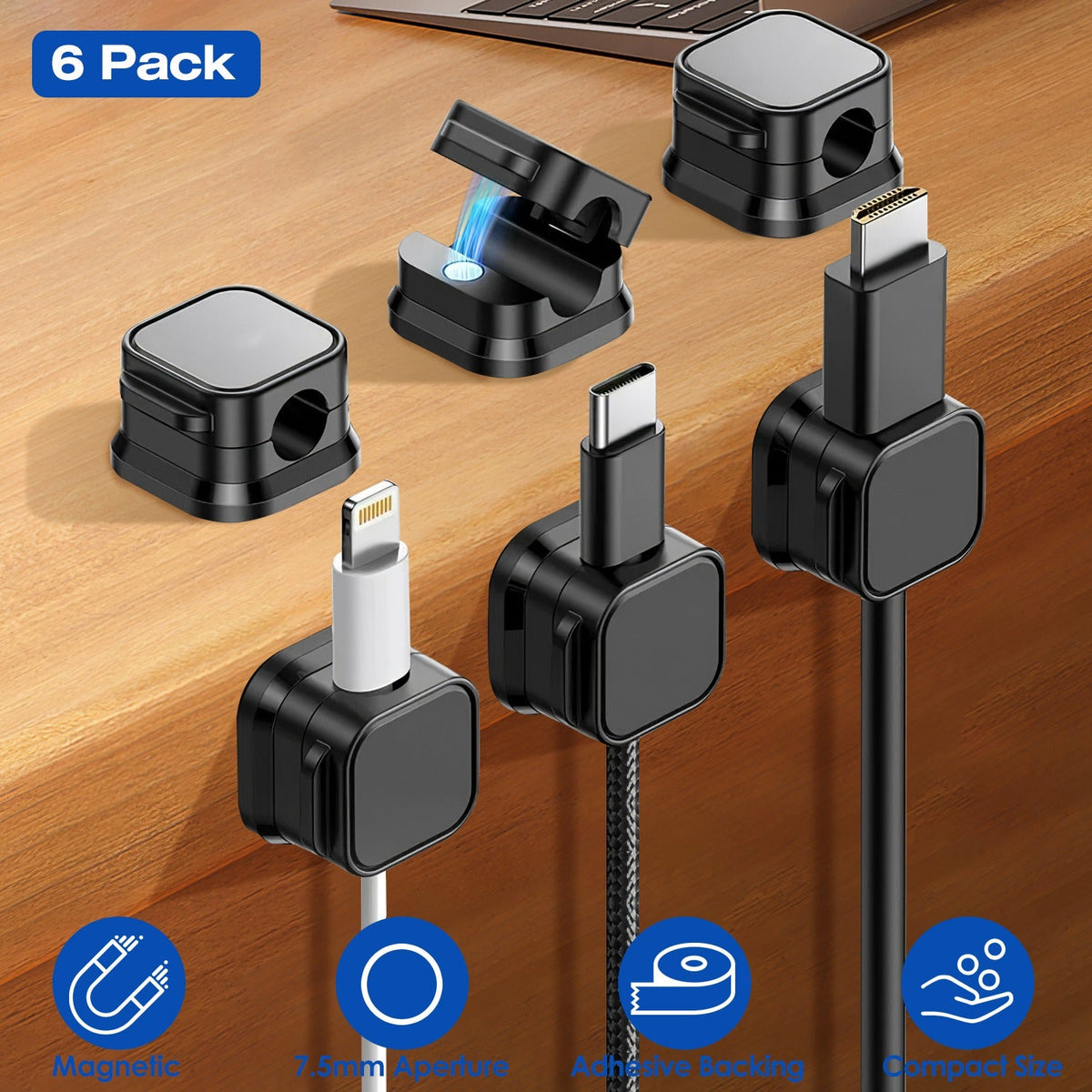 Six black magnetic cable clips holding charging cables on a desk