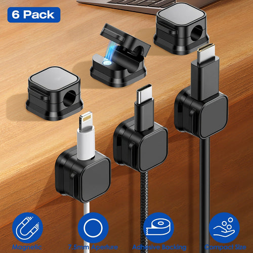 Six black magnetic cable clips holding charging cables on a desk
