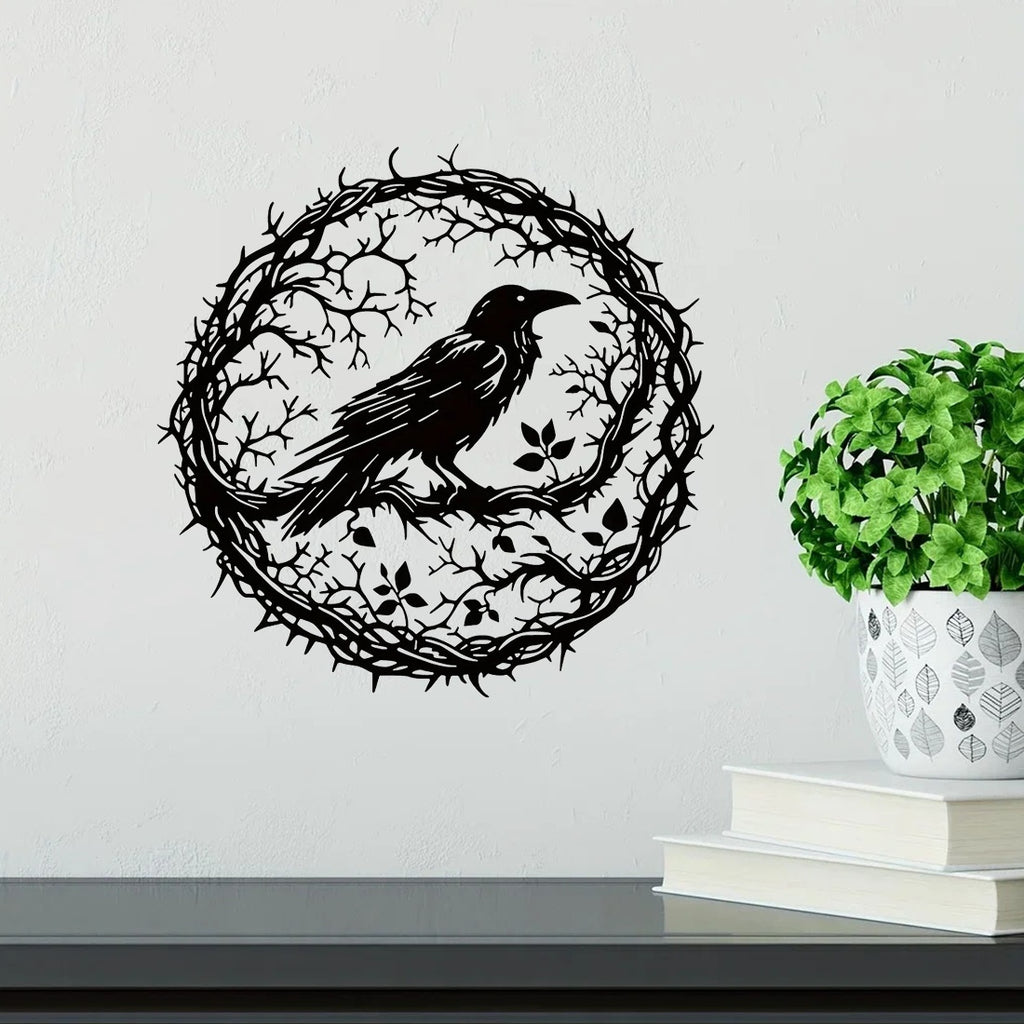 Crow wall art on a wall above a shelf with books and a plant