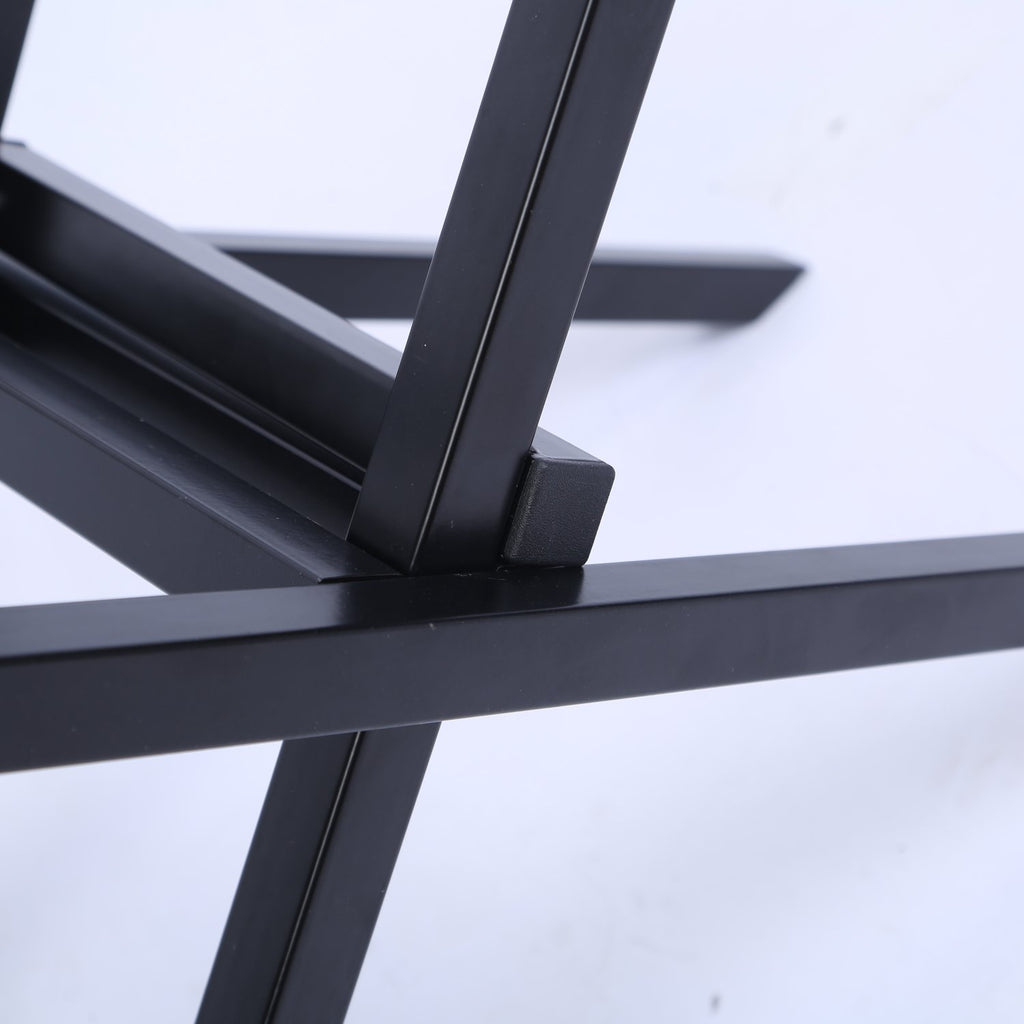 Close-up of the folding joint on the black steel firewood rack